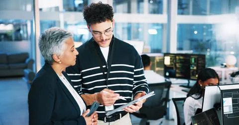 Web developer, tablet and advice with woman in office for software system or Stock Photos