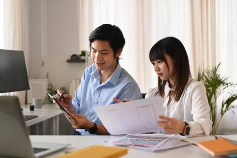 Web developer team collaborating and developing template layout for mobile Stock Photos