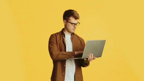 Web developer working on laptop with changing facial expressions Stock Footage 286048655
