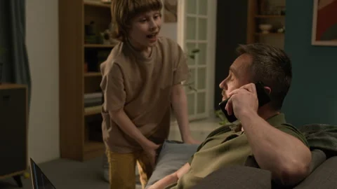 Web Developer Working Remotely and Talking on Phone, Son Asking Him Question Stock Footage 313747511