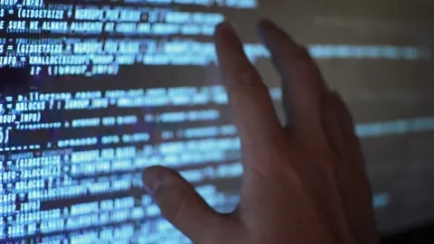 Web developer's hand monitoring code program for software Stock Footage 199019944