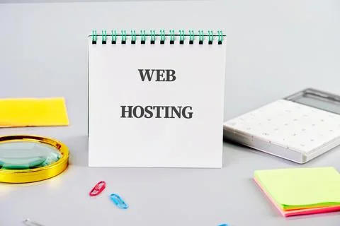 Web hosting concept highlighted on a notepad surrounded by various office sup Stock-Fotos