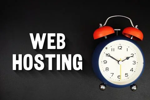 Web Hosting text with alarm clock on black background Fotos Stock