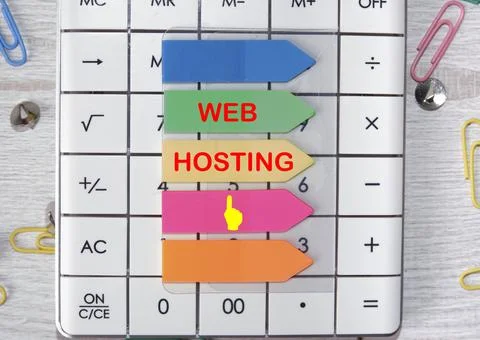 WEB HOSTING text is written on the stickers that are on the calculator Stock Photos