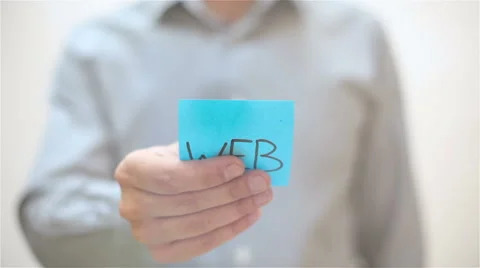 Web. A man sticks a note on transparent screen Stock Footage 67830024
