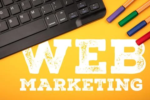 Web Marketing Text With Computer Keyboard and Color Markers on Yellow Backg.. Stock-Fotos