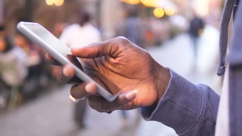 Web, social – close up on black man's hand typing on keypad phone Stock Footage 240338985