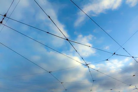 Web of tram cables with sky and clouds in background Stock Photos
