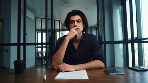 Web view of serious young startup man listening business partner during video Stock Footage 156702612