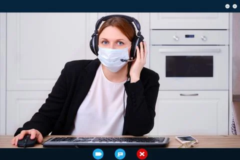 Webcam screen when making an online video call with a woman in medical mask,  Foto stock