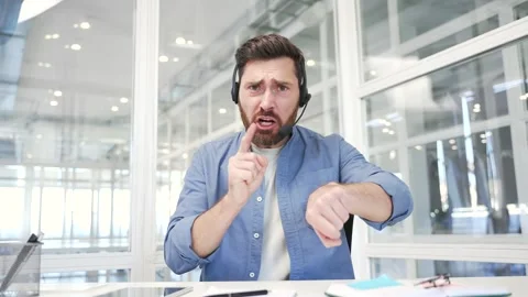 Webcam view. Angry businessman in headset arguing talking on video call  Stock Footage 305694478