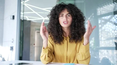 Webcam view. Angry female executive arguing on video call looking at camera  Stock Footage 303899879