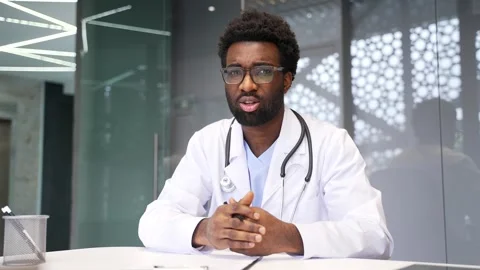 Webcam view of confident African American doctor who talks and looks at camera  Stock Footage 337501997