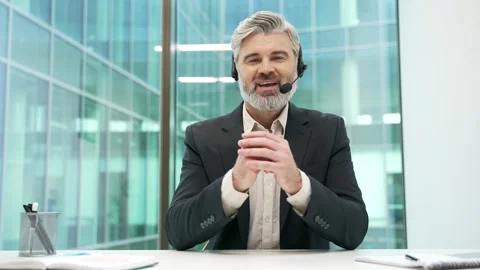 Webcam view. Confident businessman in headset talking on video call looking  Stock Footage 312732434