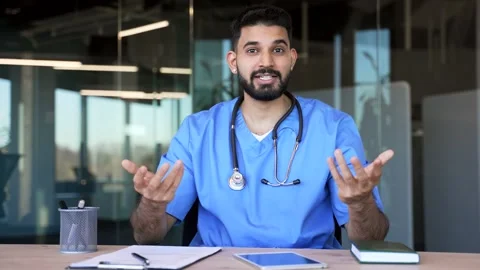 Webcam view. Confident doctor talking on video call sitting in hospital office  Stock Footage 305652745