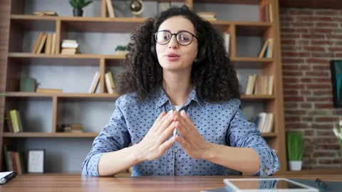 Webcam view. Confident woman in headset talking on video call looking in camera  Stock Footage 320415979