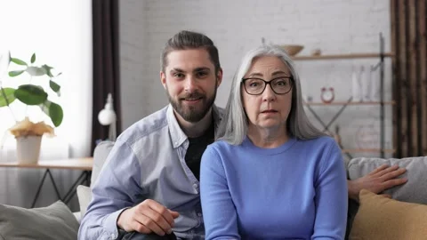 Webcam view. Handsome young man with senior mature mother talking to web camera 스톡 동영상 164532891