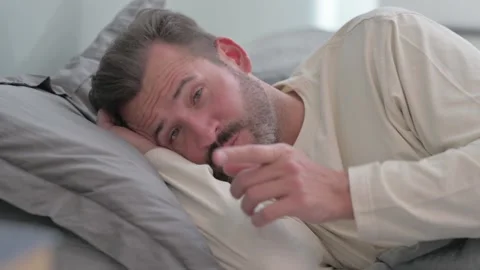 Webcam View of Middle Aged Man Doing Video Chat in Bed Video stock 287899317