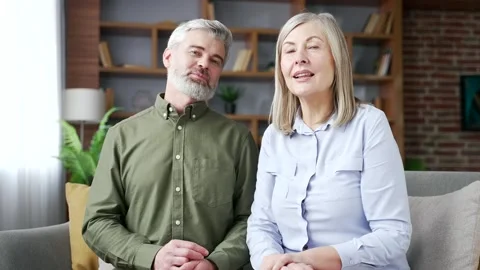 Webcam view of a senior married couple looking at camera while having an online  Stock Footage 339775755