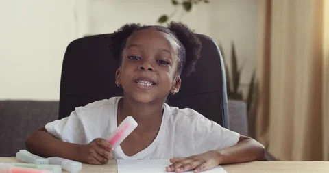 Webcam view of small mixed race girl speaks online via conference call chat Stock Footage 142065879