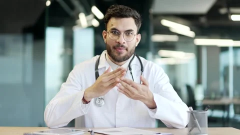 Webcam view. Smiling doctor talking on video call looking in camera in hospital  Stock Footage 300783524