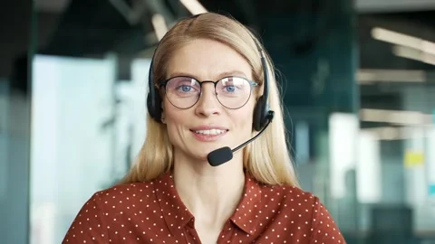 Webcam view. Smiling female in wireless headset customer service representative  Stock Footage 300881817