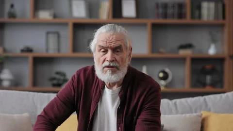 Webcam view. Smiling handsome elderly gray-haired man talking to web camera Video stock 197413151