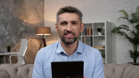 Webcam view smiling man trader broker listens questions stock market investor Stock Footage 165283847