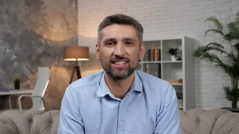 Webcam view smiling man trader greets listens questions stock market investors Stock Footage 166175740