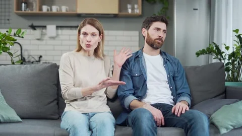 Webcam view of stressed married couple looking at the camera arguing and talking Stock Footage 231226565