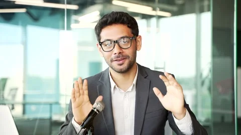Webcam view. Young businessman talking on a video call or recording a podcast  Stock Footage 251877780