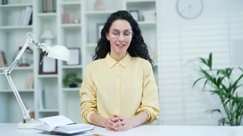 Webcam view. A young woman talking on a video call looking into the camera while Stock Footage 244452347