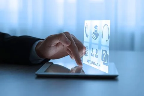 Webinar. Man using tablet at table, closeup. Virtual screen with icons over.. Stock Photos