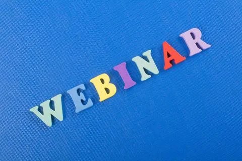 WEBINAR word on blue background composed from colorful abc alphabet block w.. Stock Photos