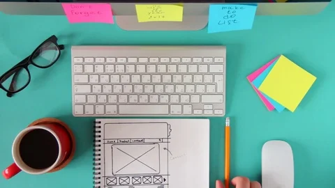 Webmaster draws the future layout of the web pages in the sketch book. Stock Footage 72427681