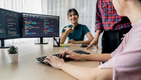 Website developer team brainstorming and sharing idea at office. Burgeoning. Stock Photos