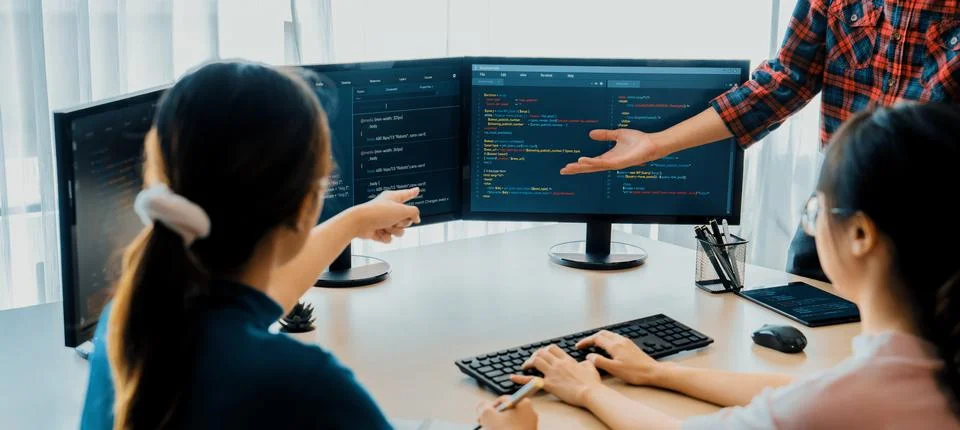 Website developer team brainstorming and sharing idea at office. Burgeoning. Stock Photos