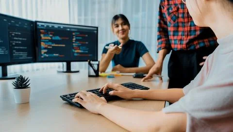 Website developer team brainstorming and sharing idea at office. Burgeoning. Stock Photos