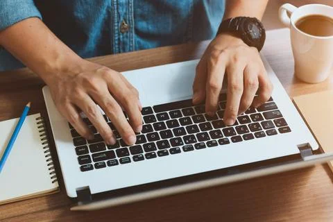 Website developer working using laptop at office on wooden. Stock Photos