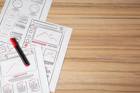 Website development. Sketches of wireframes and felt pen on wooden table, f.. Stockfoto's