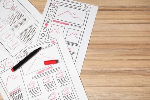 Website development. Sketches of wireframes and felt pen on wooden table, f.. Stock Photos