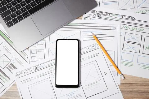 Website development. Sketches of wireframes, smartphone, pencil and laptop .. Foto stock