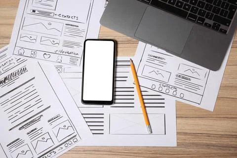 Website development. Sketches of wireframes, smartphone, pencil and laptop .. Stockfoto's