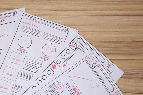 Website development. Sketches of wireframes on wooden table, flat lay 스톡 사진