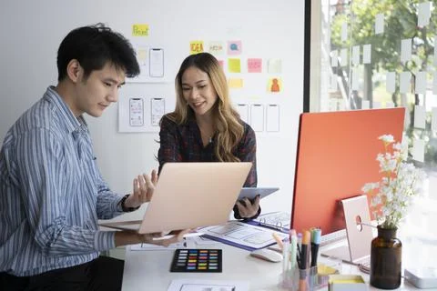 Website development team brainstorming and working on application development Stock Photos