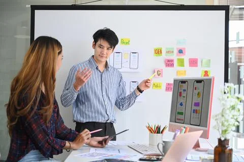 Website development team reviewing interface wireframe design for responsive web Stock Photos