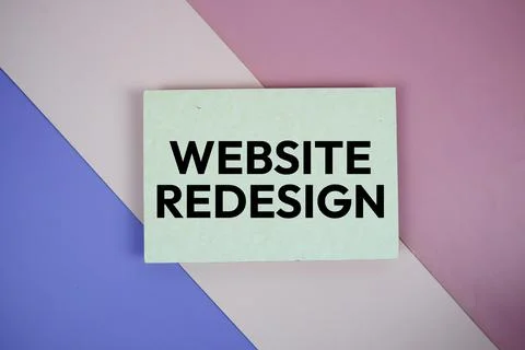 Website Redesign text on paper card on purple and pink geometric background 스톡 사진