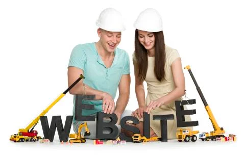Website under construction: Joyful man and woman building website-word. Stock Photos