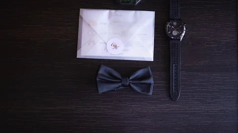 Wedding accessories. Wedding rings, bow ties, wedding invitation. Men's Watch Stock Footage 129114586