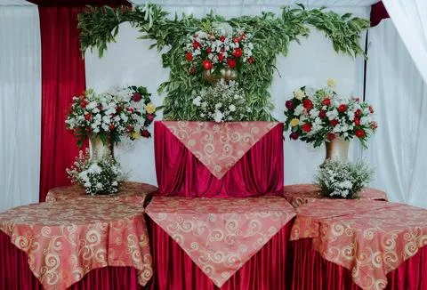 Wedding Altar Table with Red Drapery and White Floral Arrangements 库存照片